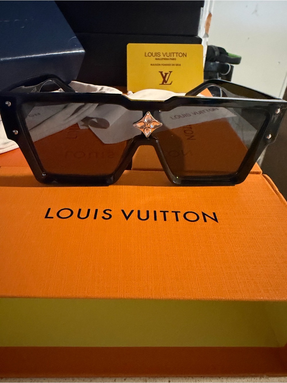 Lv12 sunglasses with logo on side and front
